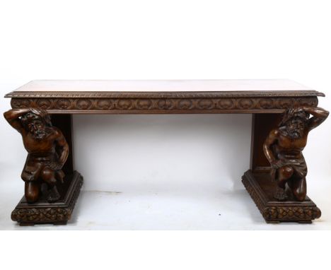 An impressive 19th century walnut hall/serving table, the top having a leaf carved edge with 2 carved frieze drawers, support