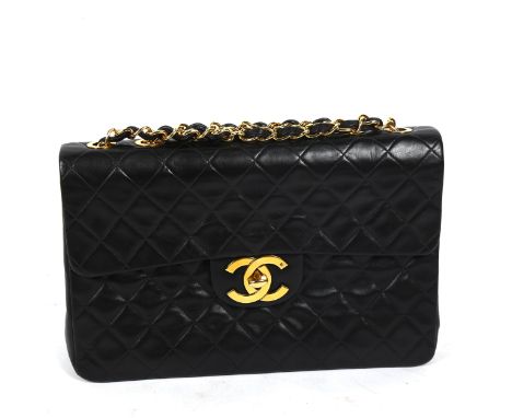 CHANEL - a Maxi Flap XL black lambskin handbag, with burgundy lining, serial no. 2864511, 1991, with authentication card and 