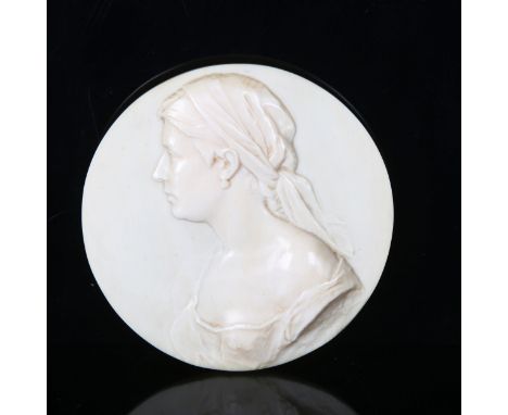 A circular relief carved ivory plaque, depicting portrait of a young woman, signed on reverse R Haller, diameter 11.5cmVery g