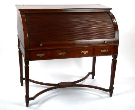 An Edwardian mahogany tambour-front writing desk, with slide-out fitted interior, 3 frieze drawers and shaped stretcher, widt
