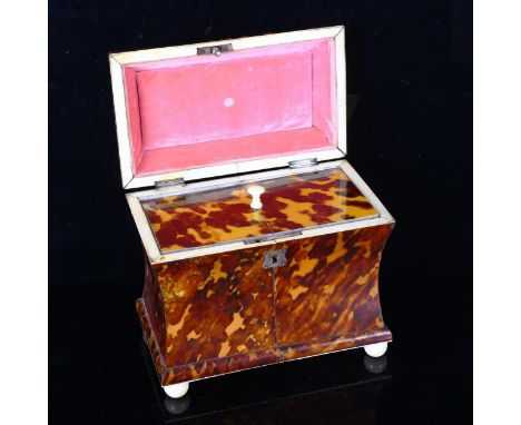 A 19th century tortoiseshell sarcophagus-shaped tea caddy, with ring handle, ivory ball feet and inner lid, length 18cmThere 