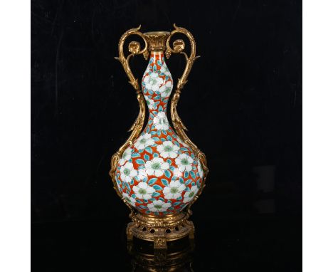 A Chinese porcelain and ormolu lamp base, with painted floral design, 6 character mark, height 38cm, base drilledAll in good 