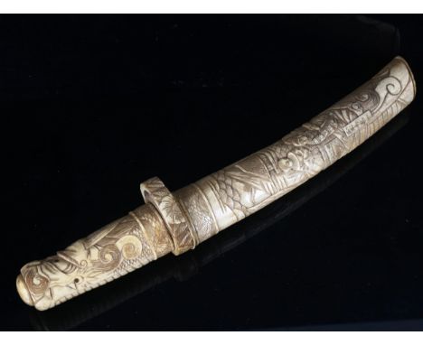 A Japanese bone dagger with relief carved decoration, early 20th century, length 37cm 