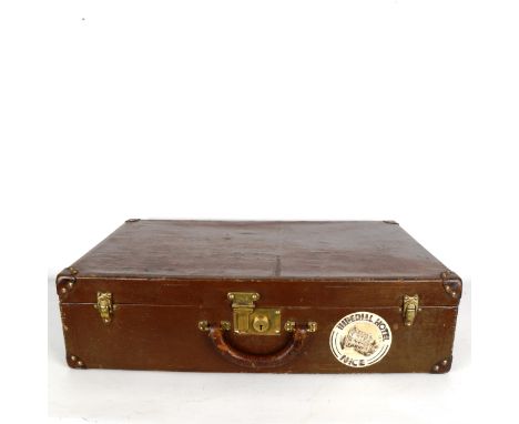 LOUIS VUITTON - a Vintage brass-mounted suitcase, with original travelling labels, original label inside lid and serial no. 7