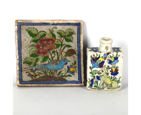 An Islamic faience glazed pottery tile, with painted decoration, 20cn x 20cm, and a similar painted and glazed pottery flask,