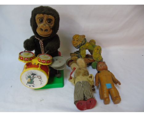 4 old toys to include a monkey playing the drums and a rabbit