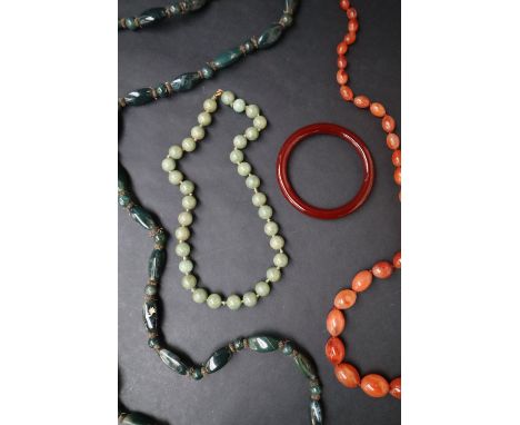 A light green hardstone beaded necklace, possibly jade, together with other hardstone necklaces and a bangle