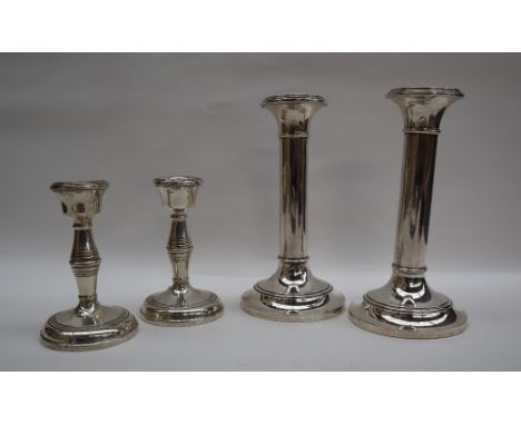A pair of George V silver desk candlesticks, with ring turned columns on a spreading foot, Birmingham, 1924, 16.5cm high toge