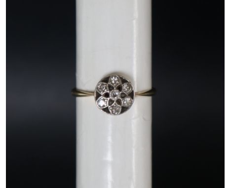 An 18ct yellow gold and platinum daisy ring, set with seven old round cut diamonds, size P, approximately 2.5 grams CONDITION