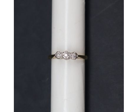 A three stone diamond ring, to a white metal setting and 18ct yellow gold shank, size L 1/2, approximately 2.5 grams