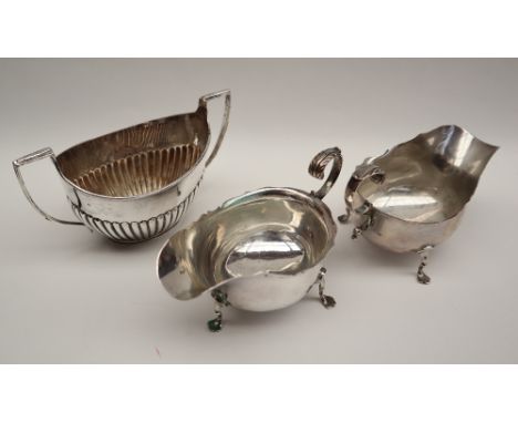 A pair of late Victorian silver sauce boats with a shaped rim and leaf capped scrolling handle, London, 1900, Charles Stuart 