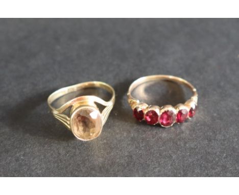 A five stone garnet ring, to a yellow metal setting and shank, size R together with a citrine set dress ring, size R, overall