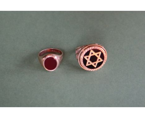 A 9ct gold ring with star of David motif, size M together with a 9ct gold hardstone set signet ring, size H 1/2