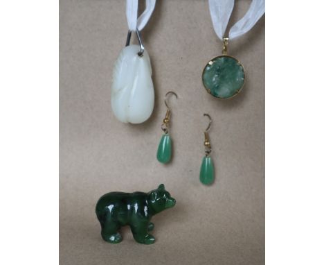 A 9ct gold mounted carved green jade panel, 23mm diameter together with a pair of jade earrings, a hardstone bear and a carve