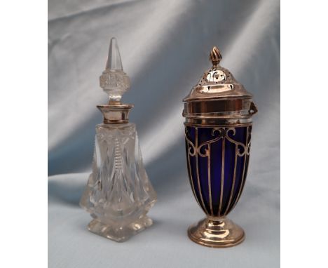An Edward VII silver and blue glass sugar caster with a flame finial and pierced domed lid, the tapering body with wirework d