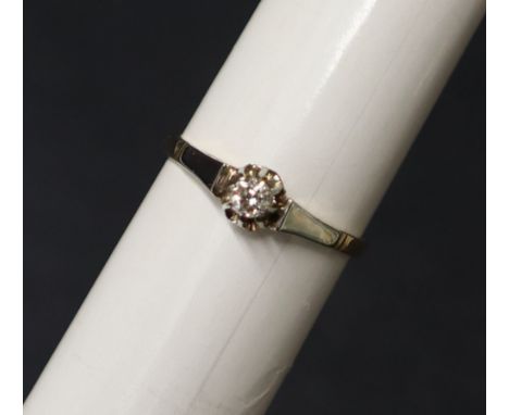 A solitaire diamond ring the round old cut diamond approximately 0.10cts to a white metal setting and 14ct gold shank, size O