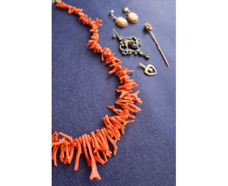 A coral necklace, comprising irregular shaped strands, 44cm long together with a 9ct gold ruby and seed pearl stick pin, a pa