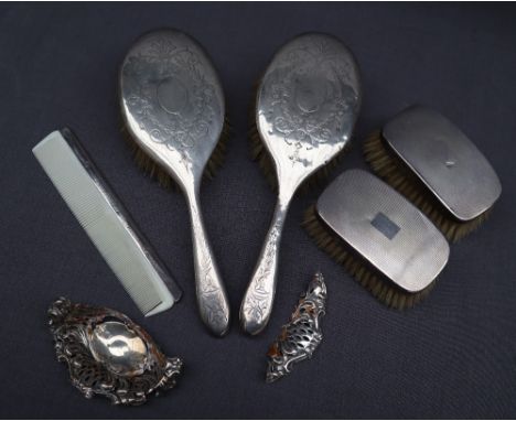 A silver backed matched part dressing table set comprising two hair brushes, two clothes brushes and a comb 