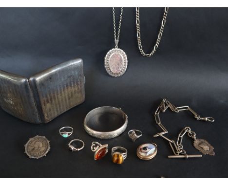 A silver locket with an enamel panel decorated with a dog, together with assorted silver jewellery including rings, bracelet,