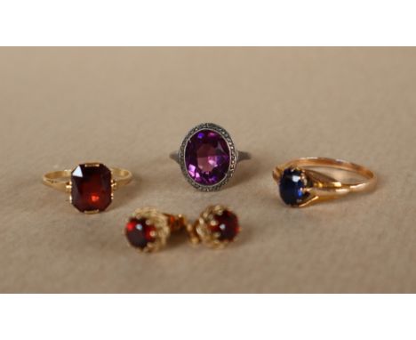 A yellow metal dress ring set with an oval faceted sapphire to a yellow metal setting and shank, size S,  together with two o
