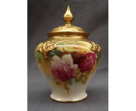 A Royal Worcester pot pouri vase and cover, the cover with a pointed finial and pierced top, the body painted with roses to a