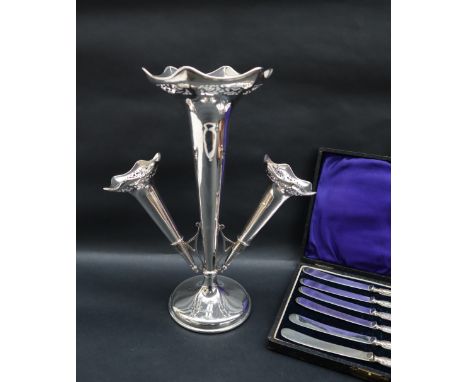 A George V silver epergne with a central flared trumpet with a pierced rim, and two smaller removable trumpets on a spreading