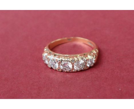 An 18ct gold five stone diamond ring, set with round old cut diamonds to an 18ct yellow gold shank, size K, approximately 4 g