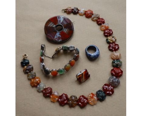 A banded agate brooch of circular form, 6cm diameter together with a banded agate necklace, 45cm long, a brooch and bracelet 