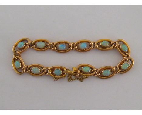 A Victorian 15 carat gold and opal bracelet, composed of twelve oval links each set to the centre with an oval opal, each sto