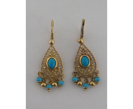 A pair of 9 carat yellow gold and turquoise pendant earrings, 5cm long, 7 gms
