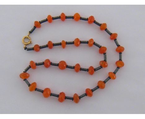 A carnelian and hermatite bead necklace, composed of alternate facetted circular carnelians and hermatite bars and spacers, t