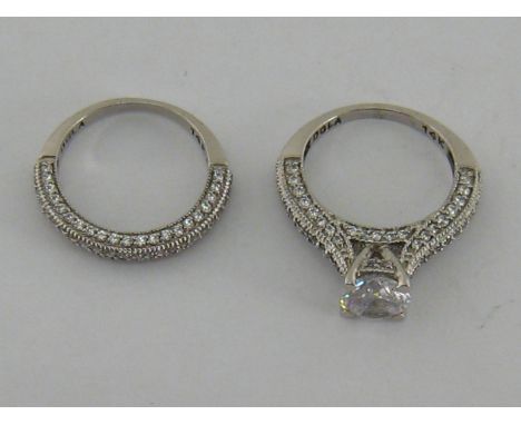Two cubic zirconia rings, each set in white gold, the shanks stamped '14k', 5.9 gms gross
