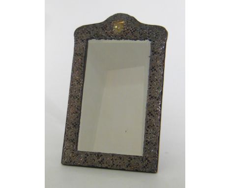 A late Victorian silver dressing table mirror by Henry Matthews, Birmingham, 1897, rectangular with shaped top, mount pierced