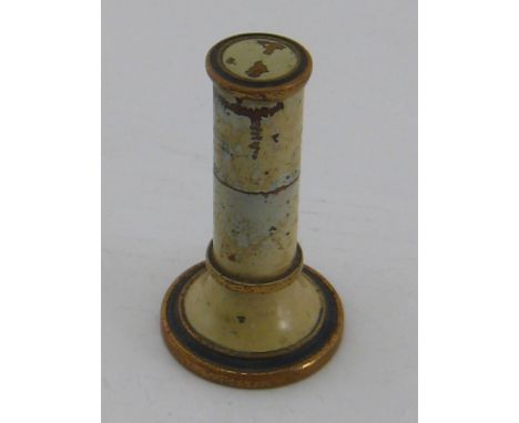 An unusual desk cigarette lighter formed as a pale green enamelled standing column with gilt highlights, the pull off top rev
