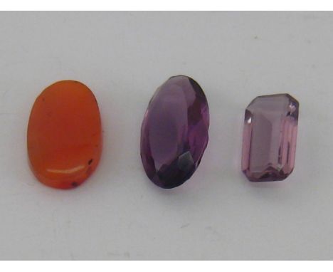 Loose stones, including an oval cut amethyst (26  x 15 x 8.2), a mixed cut amethyst (20.3x 11.3 x 6.2mm), and an oval polishe