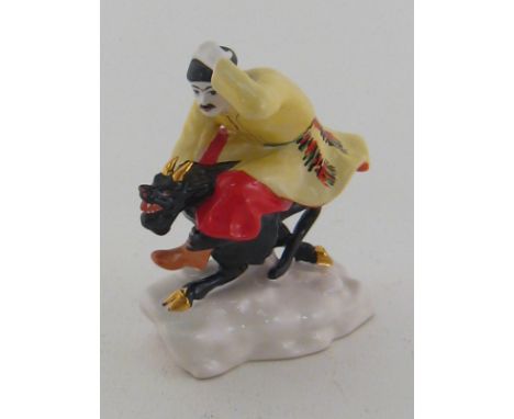 A ceramic group of a Russian peasant riding a devil. Ht. 13cm.