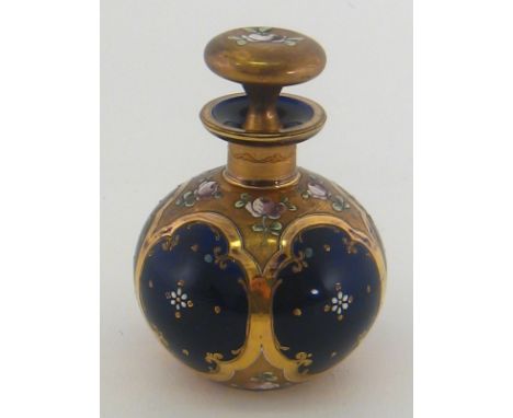 A globular Bristol blue scent flask with enamelled flowers in bright and matted gilt panels and on stopper, circa 1880. 10cm.