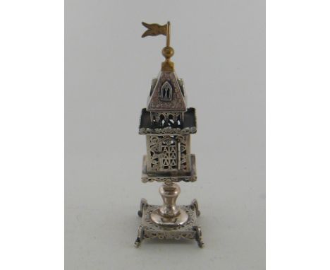 Judaica. A silver spice tower, the baluster column on square base supporting the pierced square container with galleried belf
