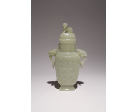 A CHINESE PALE CELADON JADE ARCHAISTIC VASE AND COVER LATE QING DYNASTY/ REPUBLIC PERIOD The body carved in relief with styli