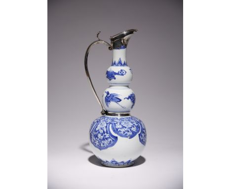 A CHINESE BLUE AND WHITE GOURD-SHAPED VASE MOUNTED AS A EWER KANGXI 1662-1722 The lower section painted with ruyi-shaped lapp