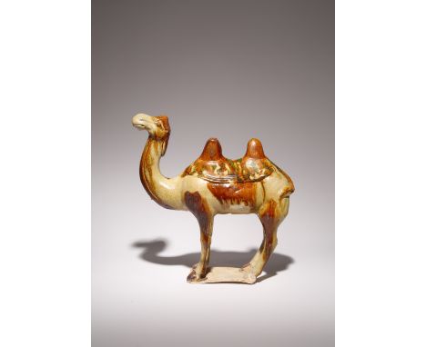 A CHINESE SANCAI POTTERY MODEL OF A BACTRIAN CAMEL TANG DYNASTY Standing four-square with its head raised and turned slightly