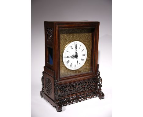 A CHINESE HARDWOOD TABLE CLOCK LATE QING DYNASTY The white enamel dial with Roman numerals, surrounded by a gilt metal frame 