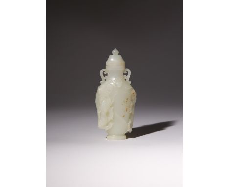 A CHINESE PALE CELADON JADE VASE AND COVER QING DYNASTY OR LATER With scroll handles to the neck, the body carved in high rel