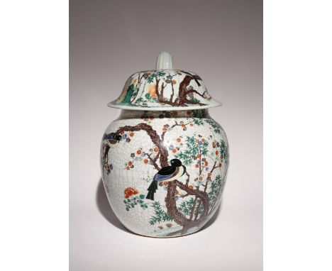A MASSIVE CHINESE CRACKLE-GLAZED JAR AND COVER 20TH CENTURY Painted in coloured enamels with a continuous scene of birds amid