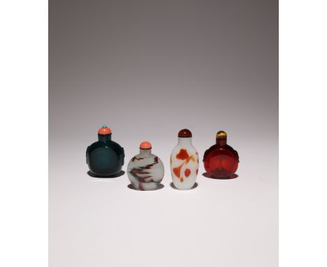 FOUR CHINESE GLASS SNUFF BOTTLES 19TH CENTURY One in ruby coloured glass, another intense viridian green, the other bottles w