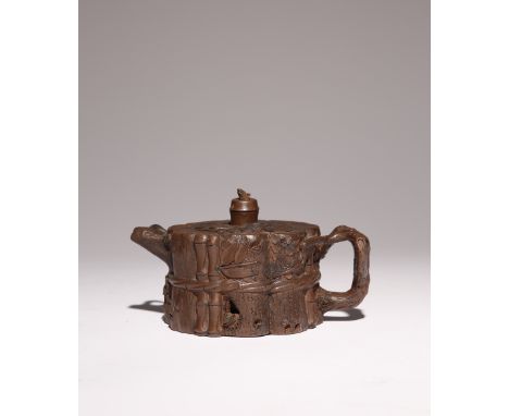 A CHINESE YIXING 'THREE FRIENDS OF WINTER' TEAPOT AND COVER QING DYNASTY The body moulded to imitate bamboo, prunus and pine,