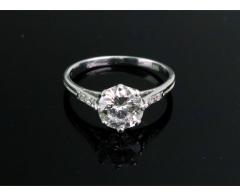 A platinum and diamond solitaire ring, circa 1930, claw set with an old cushion cut diamond, the central diamond weighs appro