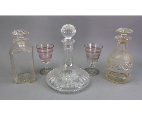 A George III style glass decanter, early 20th century, with stepped neck, diamond, facet and split cut, 23cm high, a similar 