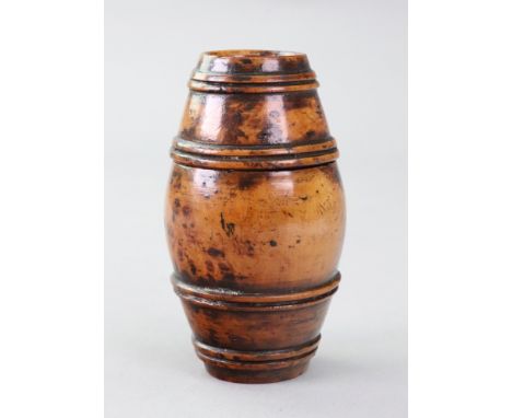 A fruitwood barrel shape box, 19th century, with pull off cover and ring turned bands, 7.5cm high.Illustrated
