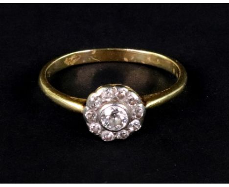 An early 20th century gold and diamond eleven stone cluster ring, centred with an old-cut diamond approximately 0.20cts withi